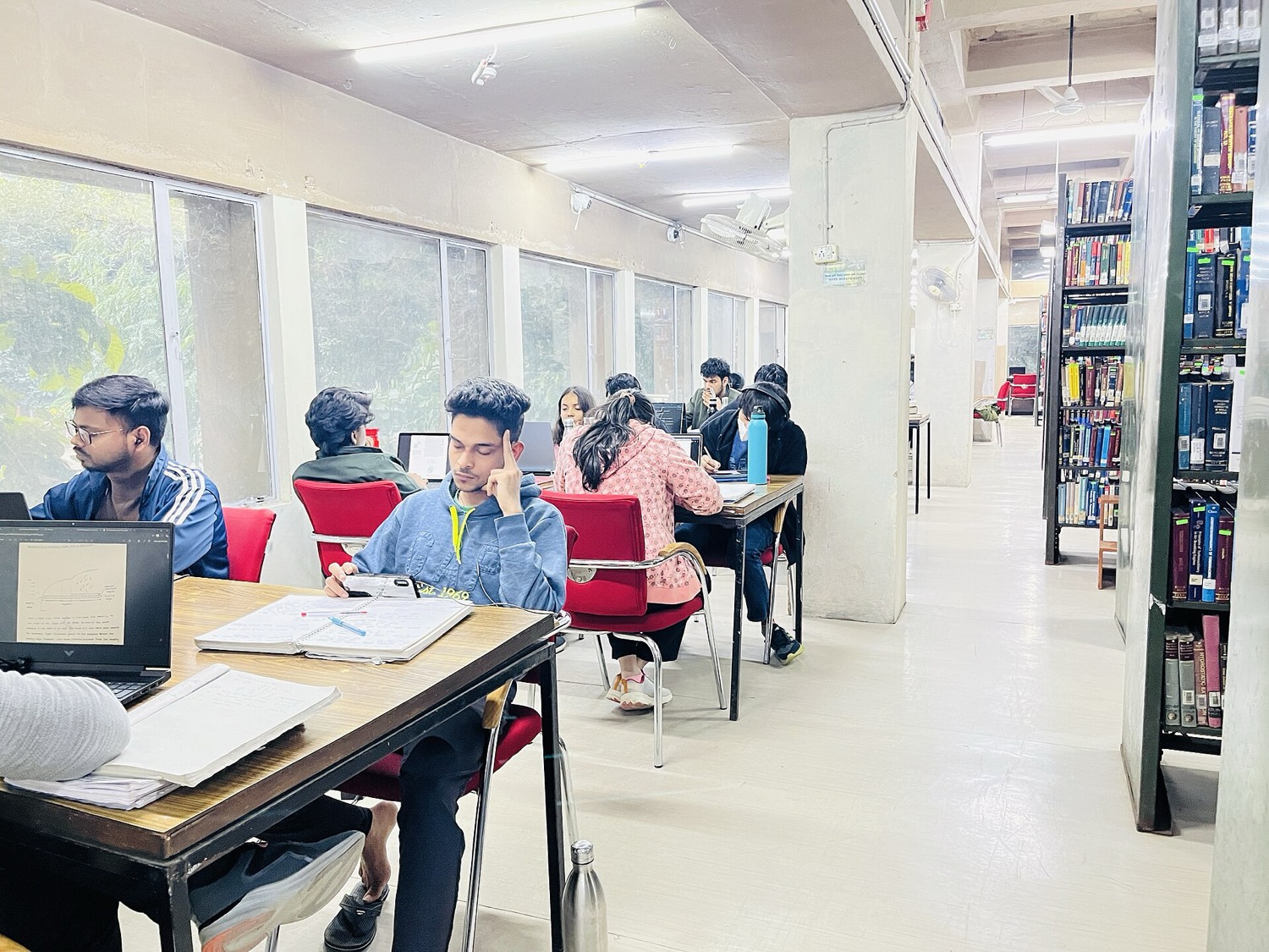 Students studying at desks in the Central Library reading hall, IIT Delhi