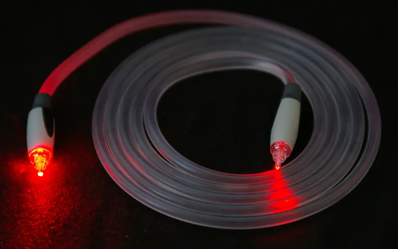 Strands of optical fibre glowing red at their tips