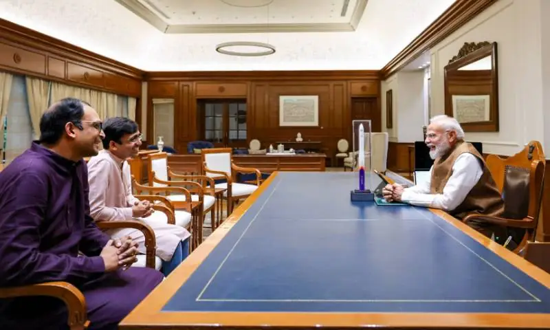 Skyroot Aerospace co-founders Pawan Kumar Chandana, in a pale pink kurta, and Naga Bharath Daka, in a purple kurta, seated at a long table