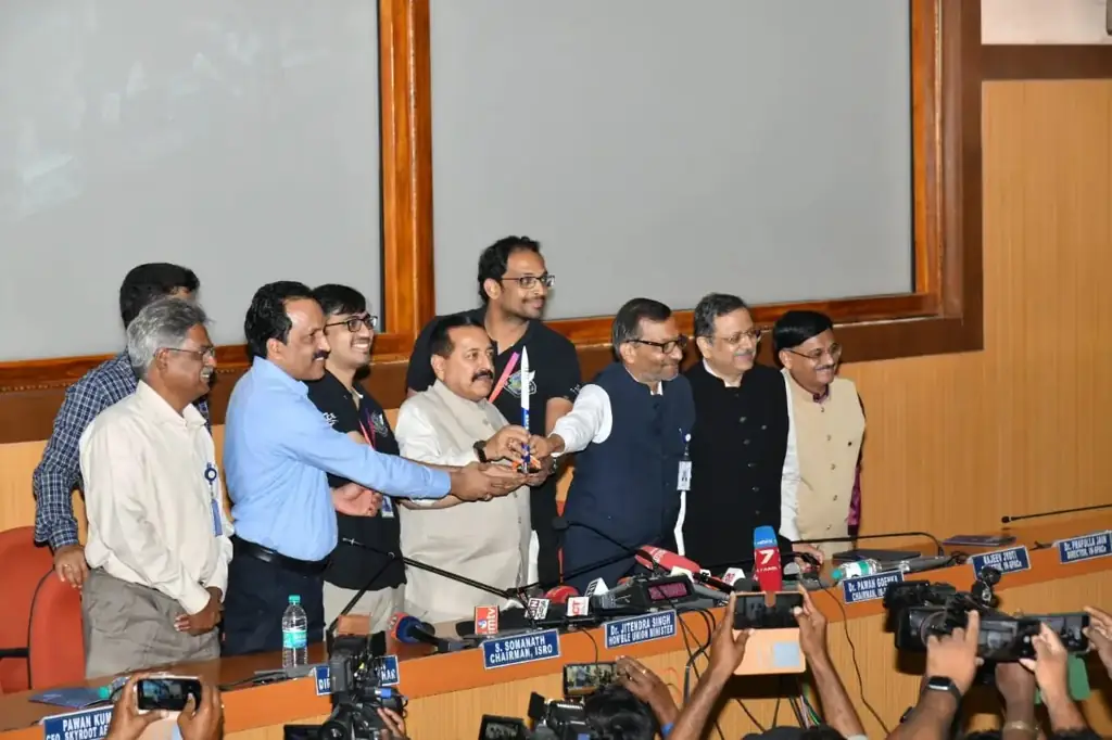 Nine people on a stage at Sriharikota hold a model of the Vikram-S rocket after its launch, with Pawan Kumar Chandana third from left in a black Skyroot t-shirt and glasses