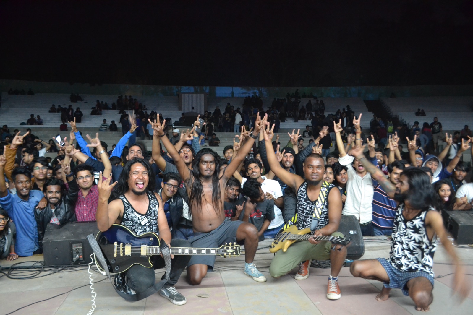 A rock band posing with fans throwing the rock-horns sign at Spring Fest, IIT Kharagpur
